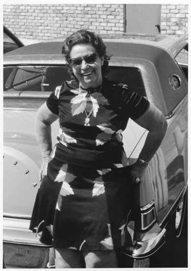 Millie Burke standing next to car